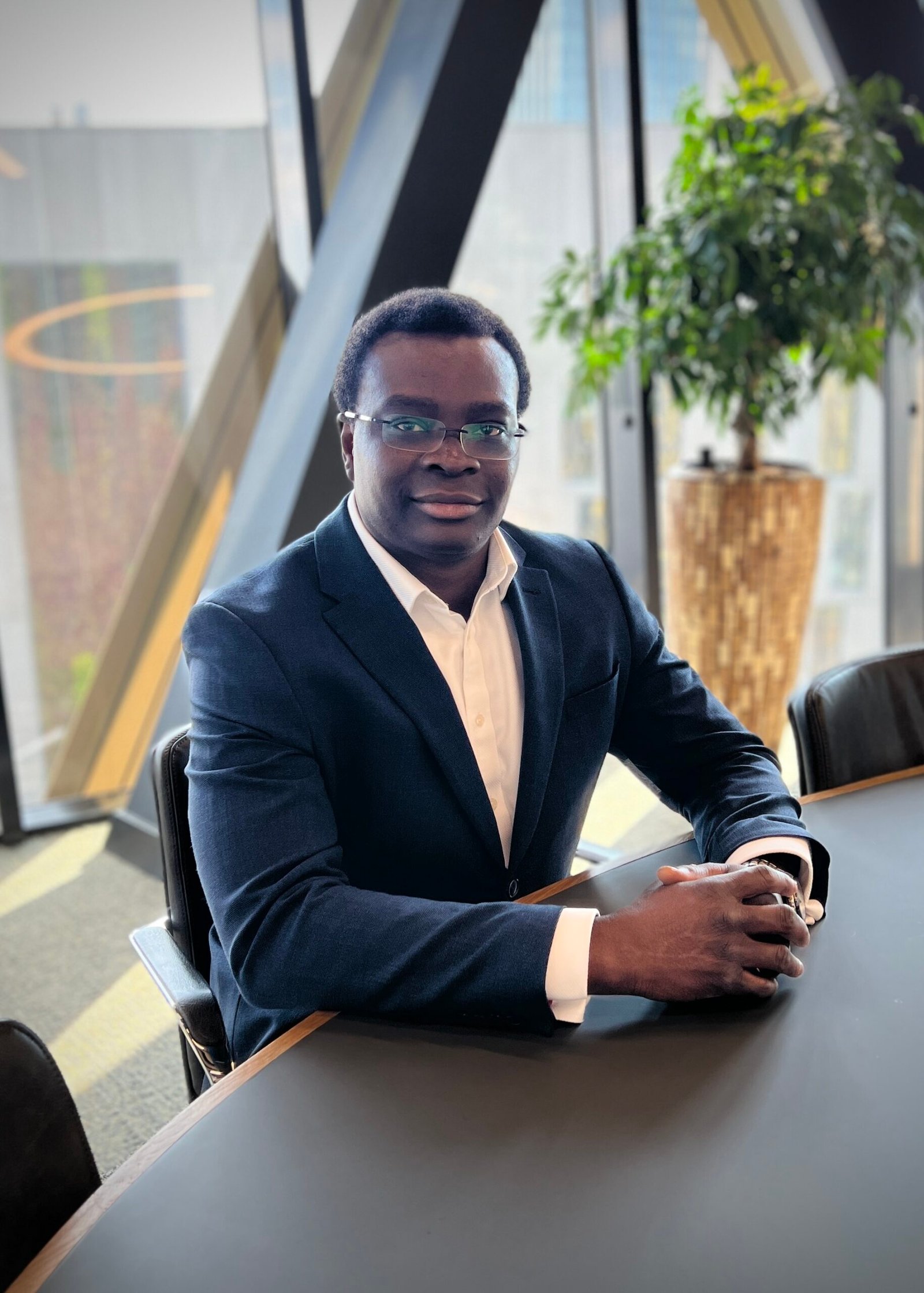 Dr Olusola Idowu at a boardroom table